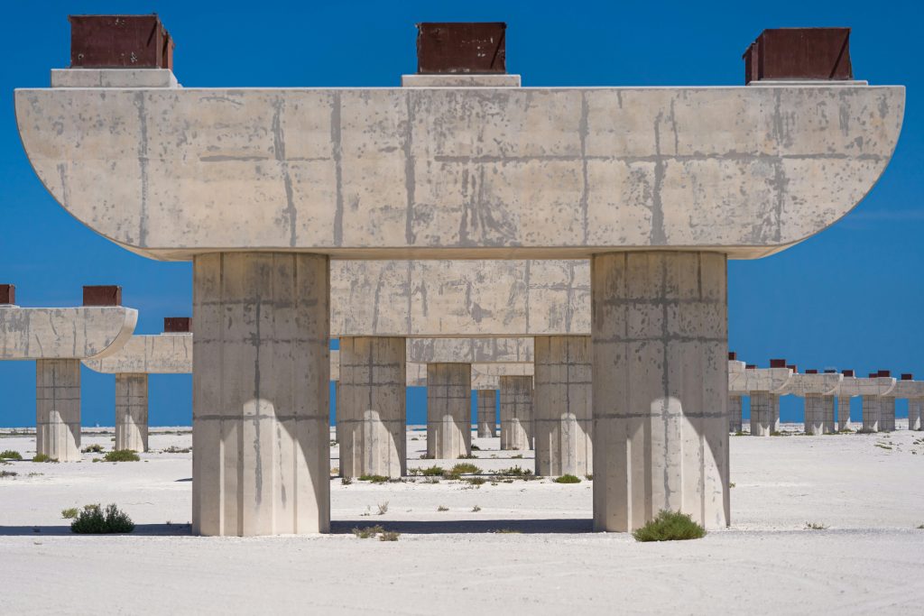 Social media foundations. Abstract image of unfinished concrete structures in Dubai desert setting.